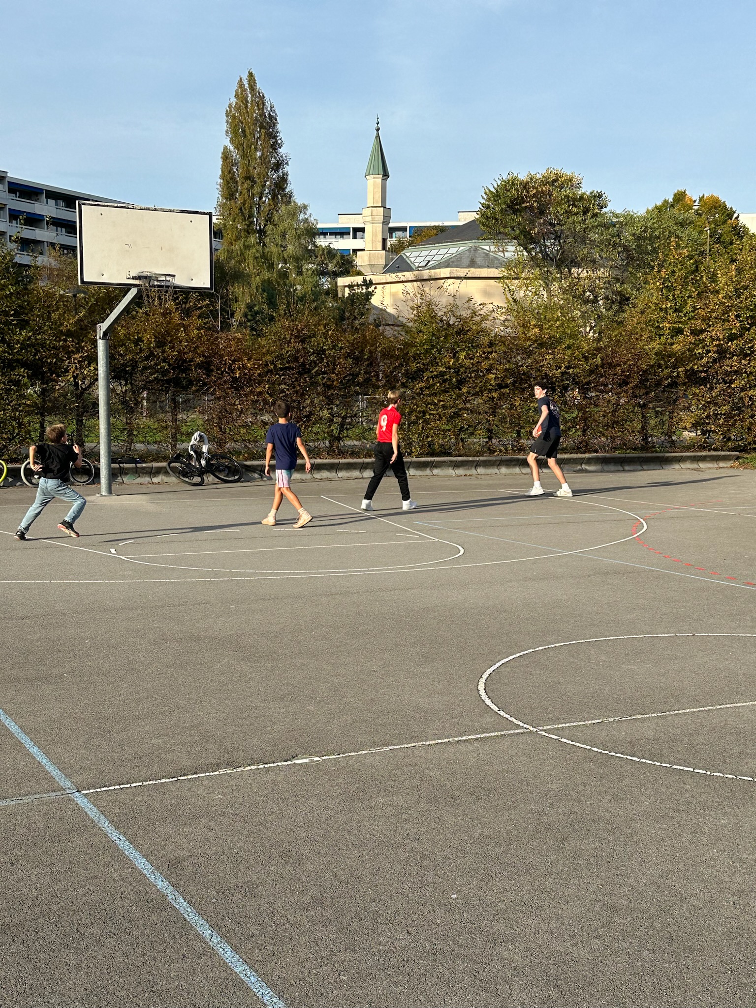 Camden playing basketball with local kids in Geneva